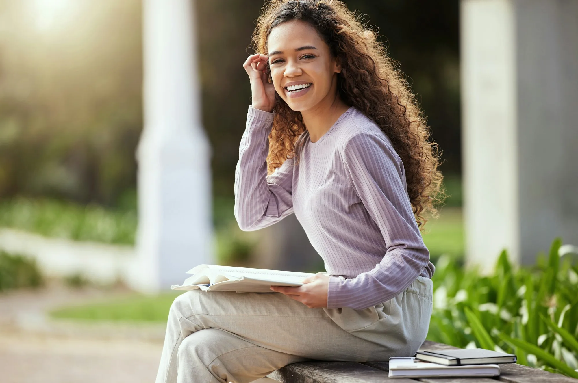 Chasing my dreams. Shot of a young female student studying in nature.