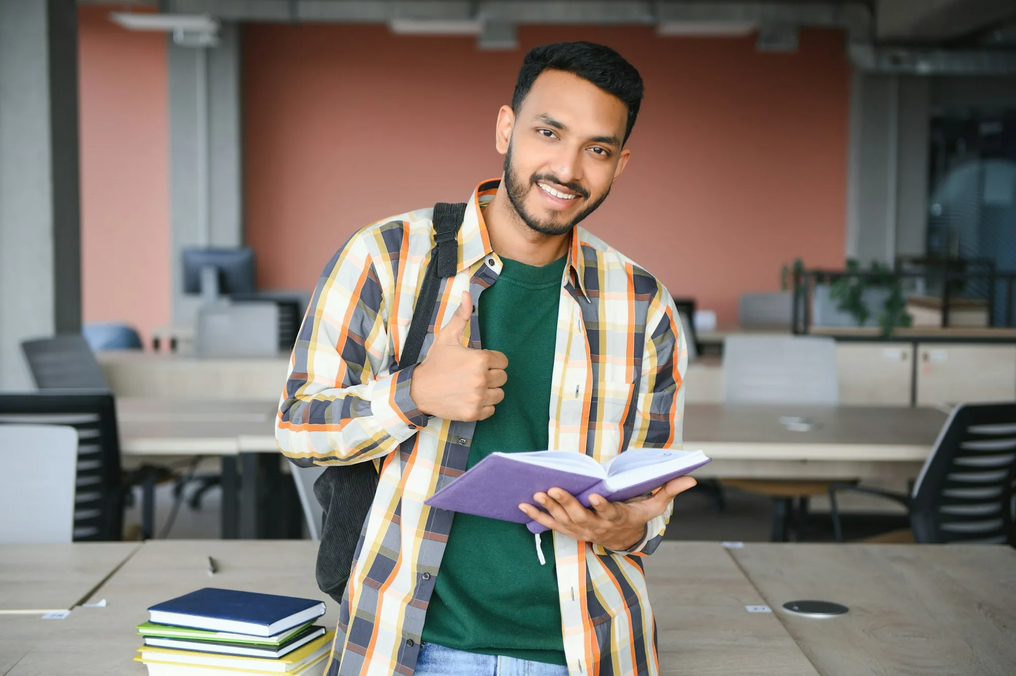 indian student with books at university