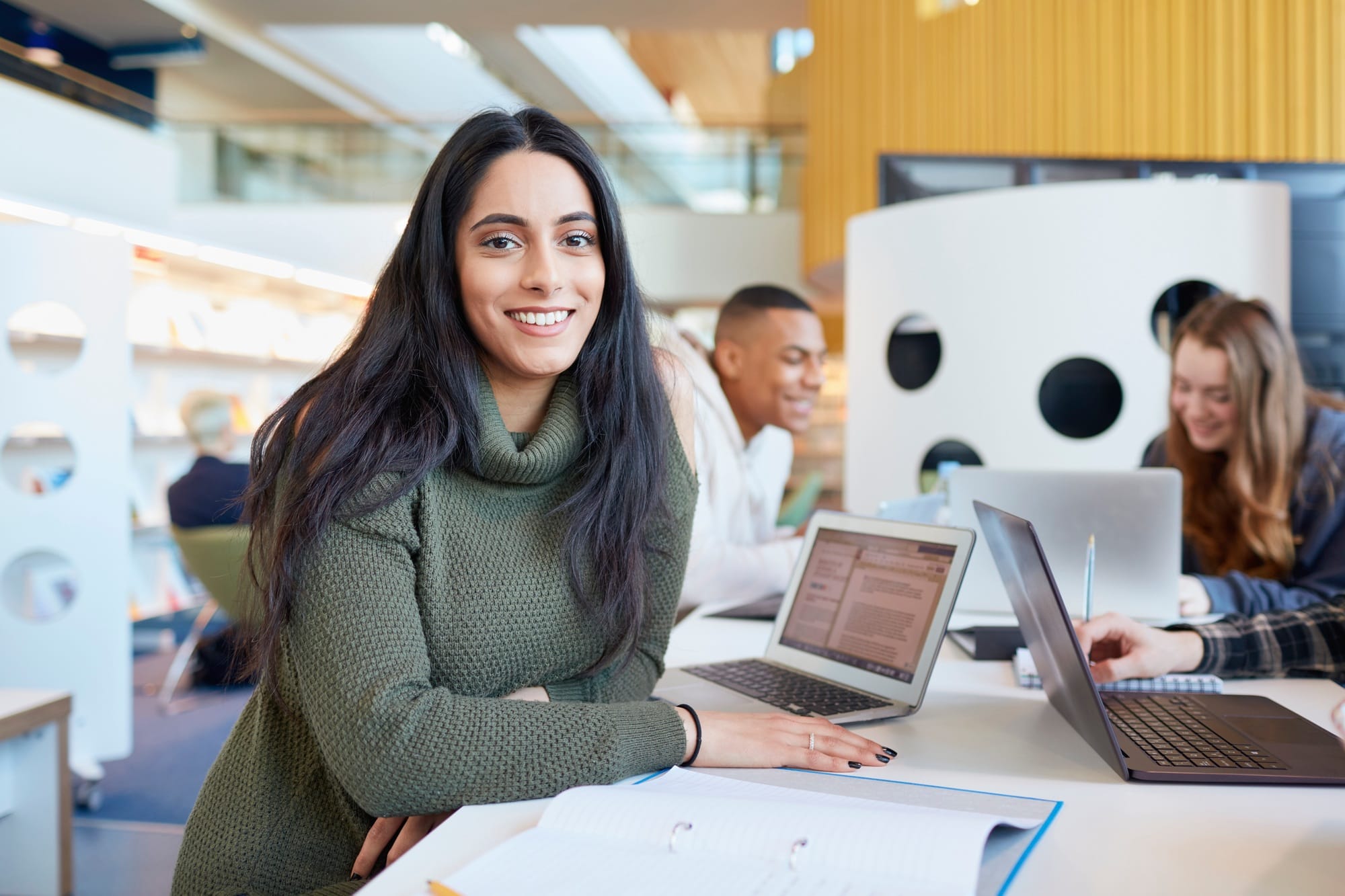 University students using laptops and digital tablet, working together