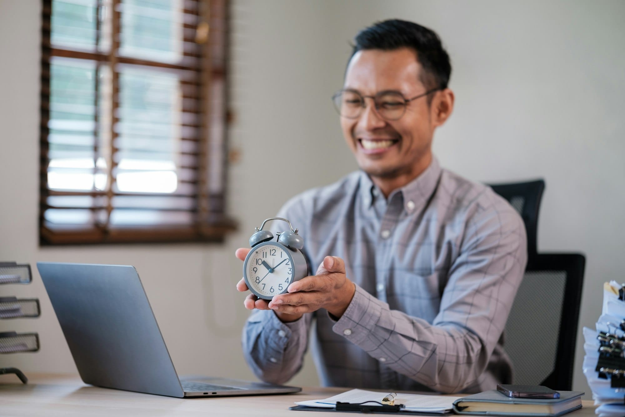 Young male employee in time management concept